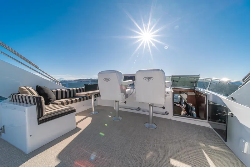 Slide: The Image of Luxurious 1998 West Bay 58 Sonship Pilothouse MY yacht deck with seating under sunny sky. - 52