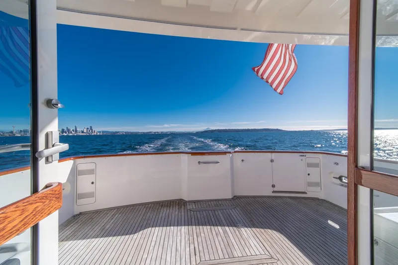 Slide: The Image of 1998 West Bay 58 Sonship Pilothouse MY cruising with city skyline and ocean view. - 55