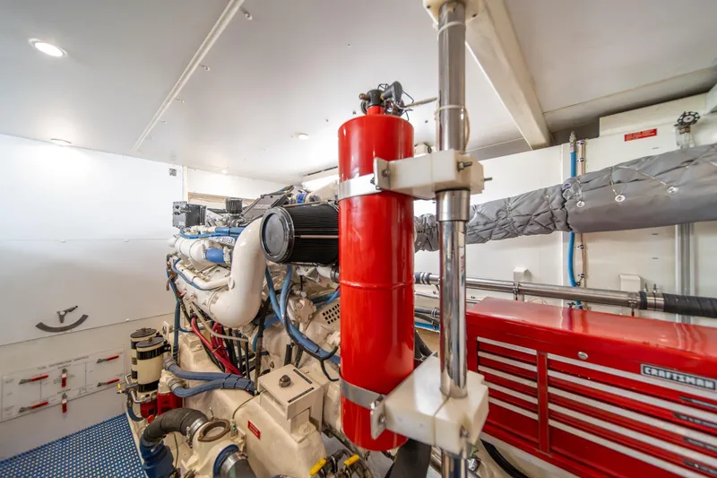 Slide: The Image of Engine room of 1998 West Bay 58 Sonship Pilothouse MY with visible machinery and tools. - 63