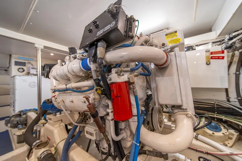 Slide: The Image of Engine room of 1998 West Bay 58 Sonship Pilothouse MY, showcasing complex machinery and components. - 66