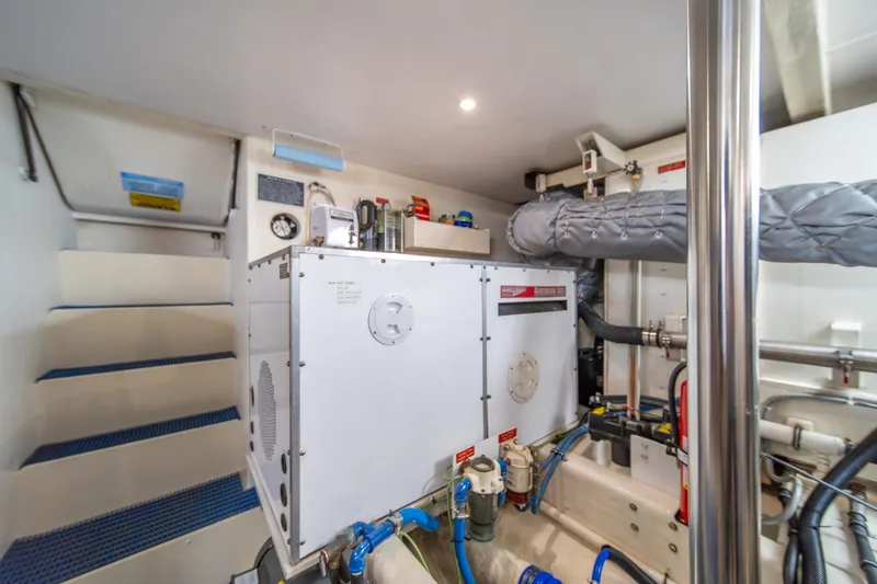 Slide: The Image of Engine room of 1998 West Bay 58 Sonship Pilothouse MY with equipment and piping. - 69