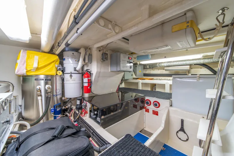 Slide: The Image of Engine room of 1998 West Bay 58 Sonship Pilothouse MY, featuring equipment and storage. - 73