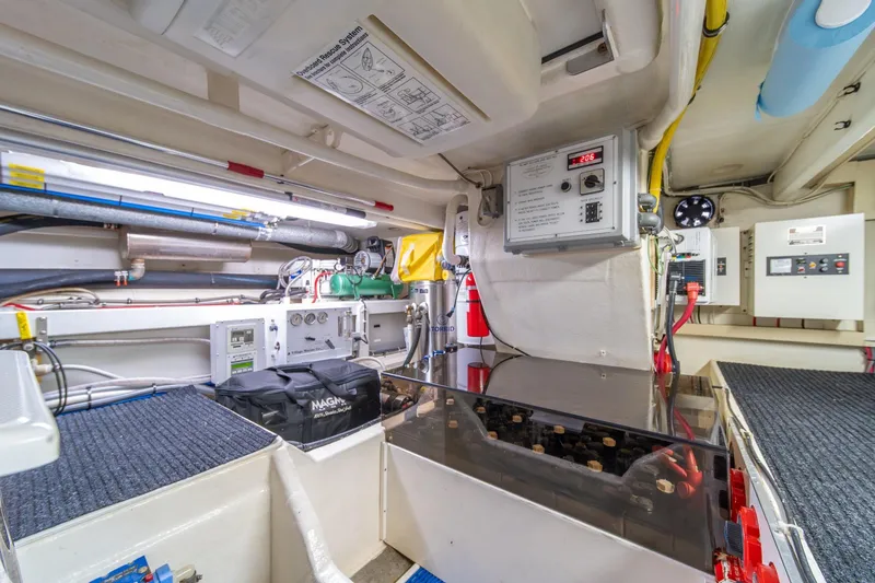 Slide: The Image of Engine room of 1998 West Bay 58 Sonship Pilothouse MY, featuring control panels and equipment. - 74