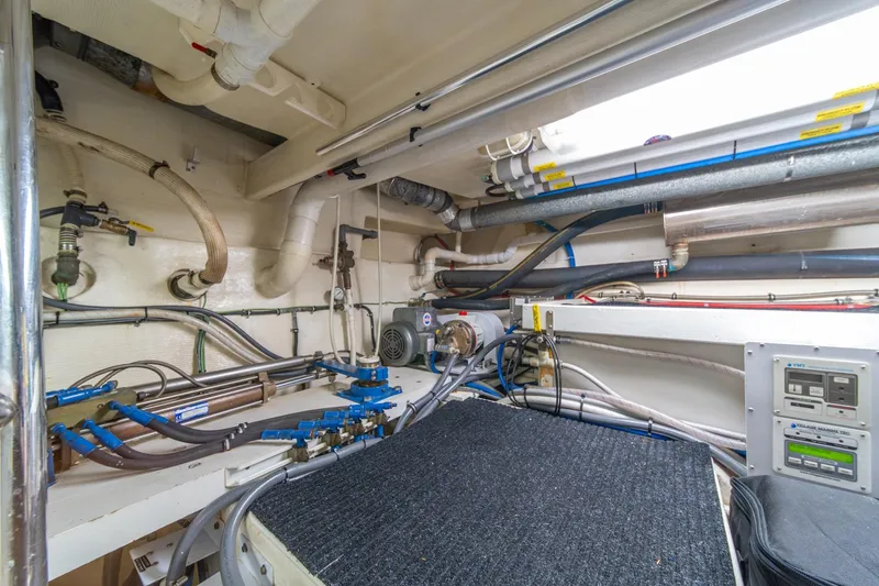 Slide: The Image of Engine room of 1998 West Bay 58 Sonship Pilothouse MY with visible pipes and control panels. - 75