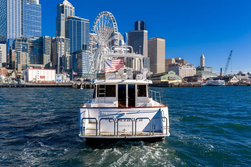 Slide: The Image of 1998 West Bay 58 Sonship Pilothouse MY cruising near urban skyline and Ferris wheel. - 8