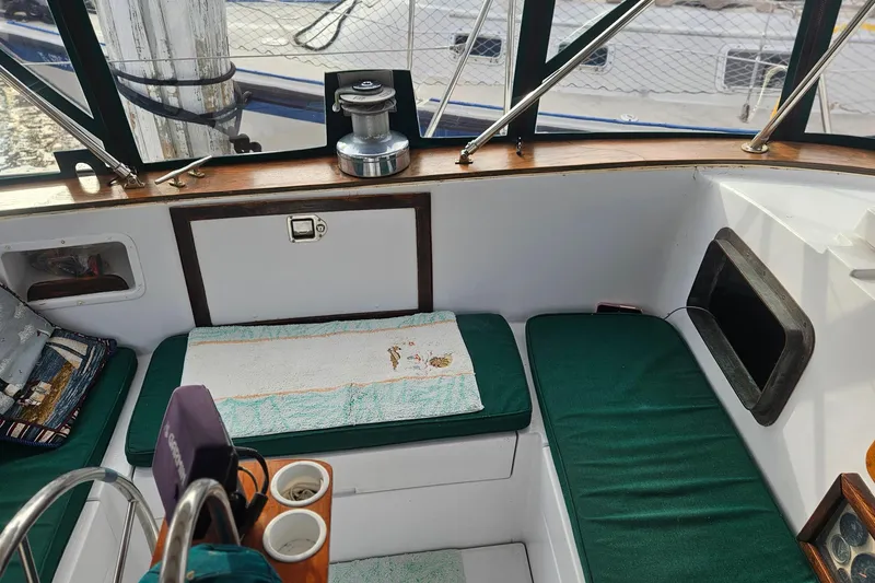 Slide: The Image of 1979 CSY 44 CC sailboat cockpit with green cushions and winch. - 12