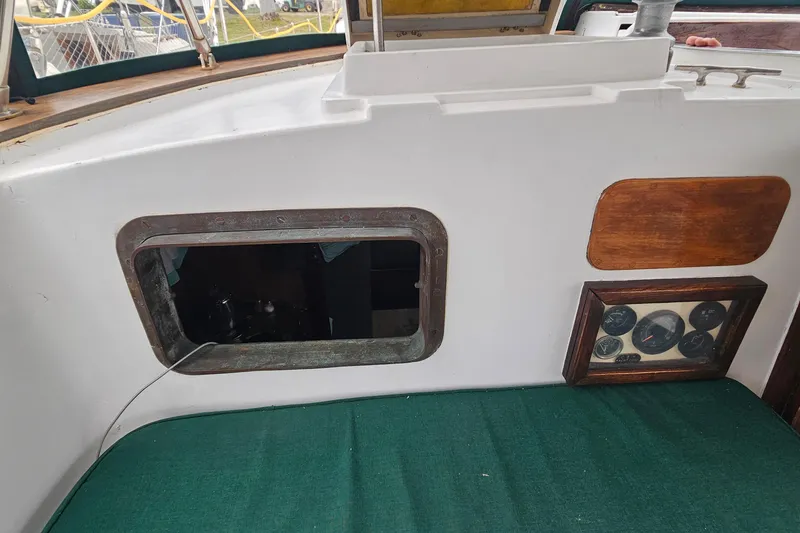 Slide: The Image of 1979 CSY 44 CC yacht interior with gauges and green cushion. - 13