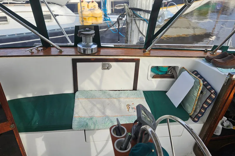 Slide: The Image of 1979 CSY 44 CC cockpit with green cushions, steering wheel, and nautical equipment. - 15