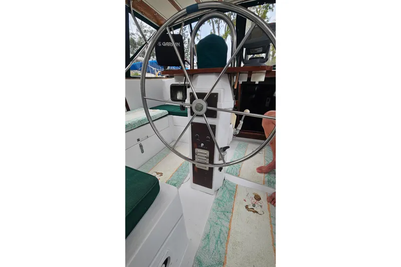 Slide: The Image of Interior view of 1979 CSY 44 CC sailboat cockpit with steering wheel and seating. - 16