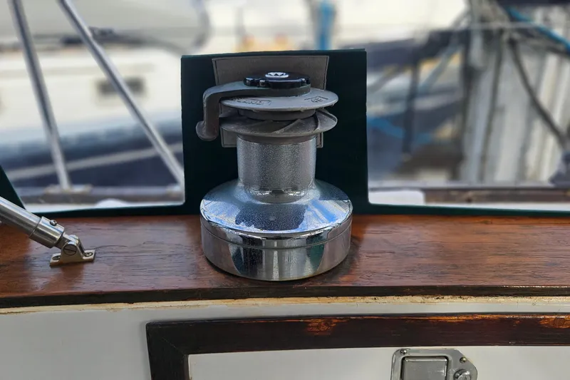 Slide: The Image of Chrome winch on 1979 CSY 44 CC sailboat, mounted on wooden surface. - 18