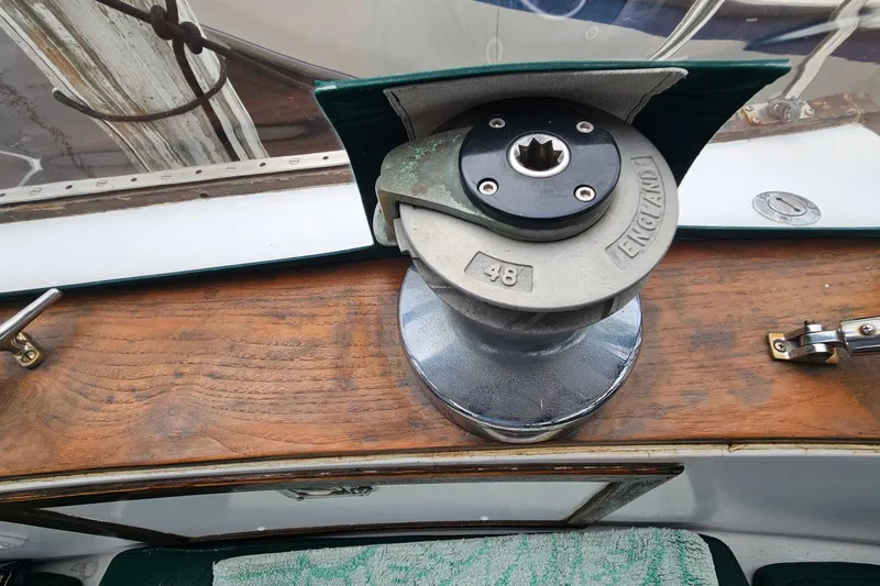 Slide: The Image of 1979 CSY 44 CC sailboat winch on wooden deck, marked "England 48". - 19