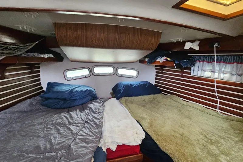 Slide: The Image of Cozy cabin interior of 1979 CSY 44 CC sailboat with twin beds and wooden accents. - 21