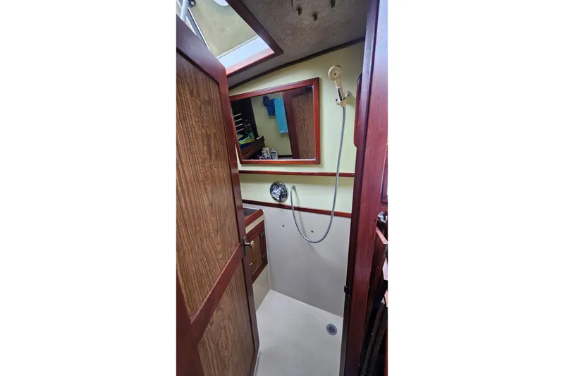 Slide: The Image of 1979 CSY 44 CC yacht bathroom with wooden door, shower, and mirror. - 22