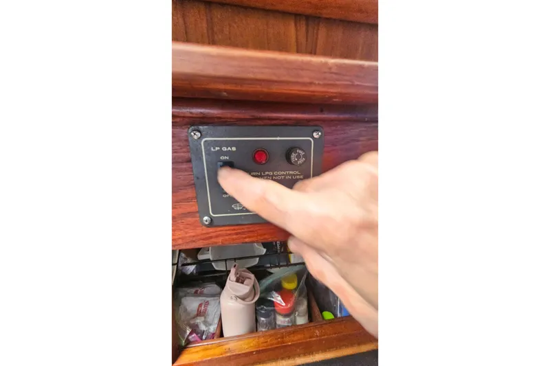 Slide: The Image of Hand operating LP gas control on 1979 CSY 44 CC yacht. - 26