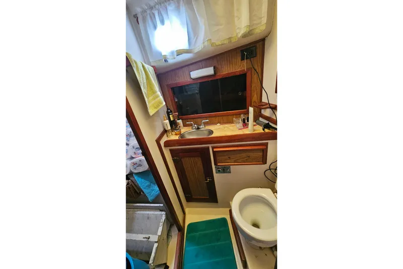 Slide: The Image of 1979 CSY 44 CC yacht bathroom with sink, mirror, and toilet. - 32