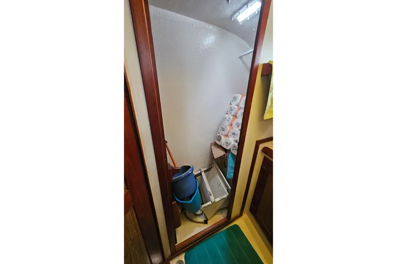 Slide: The Image of 1979 CSY 44 CC interior storage area with cleaning supplies and paper towels. - 33