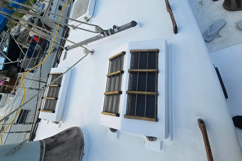 Slide: The Image of Deck of 1979 CSY 44 CC sailboat with wooden handrails and hatches. - 4