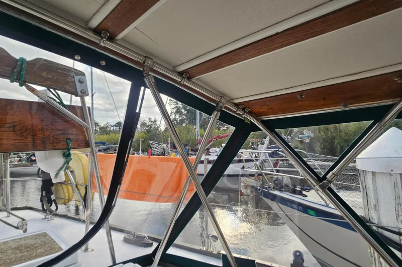Slide: The Image of 1979 CSY 44 CC sailboat interior view with marina background. - 42