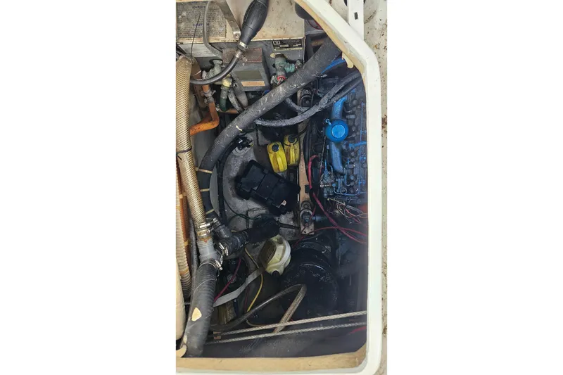 Slide: The Image of Engine compartment of a 1979 CSY 44 CC sailboat, showing hoses and mechanical components. - 47