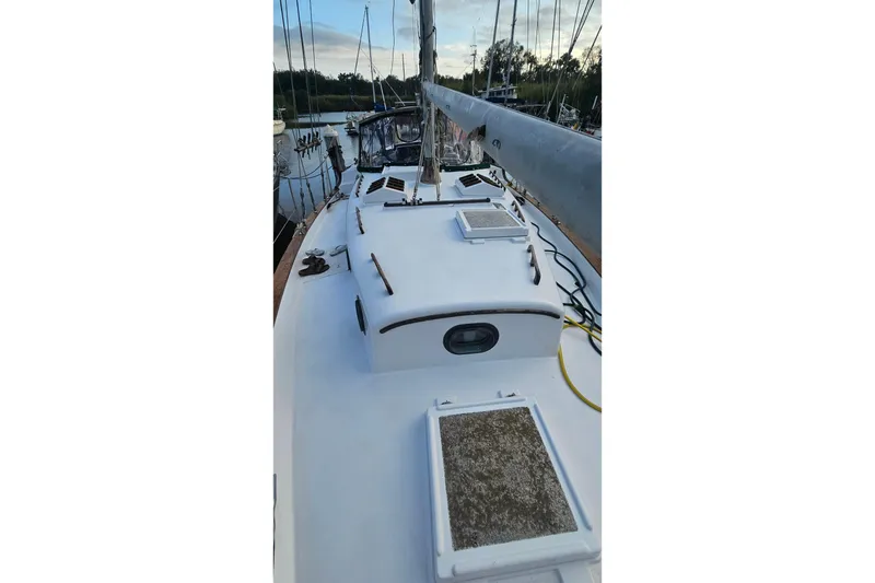 Slide: The Image of 1979 CSY 44 CC sailboat deck with hatches and rigging in a marina. - 5
