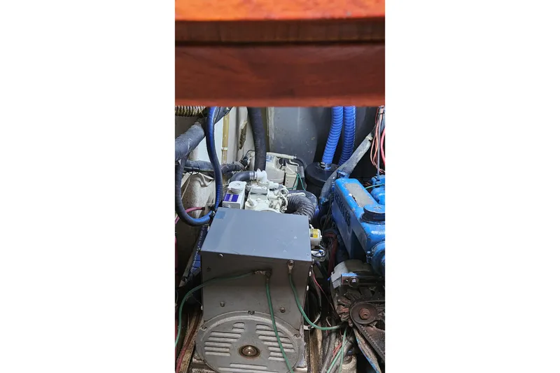 Slide: The Image of Engine compartment of a 1979 CSY 44 CC sailboat, featuring various mechanical components. - 50