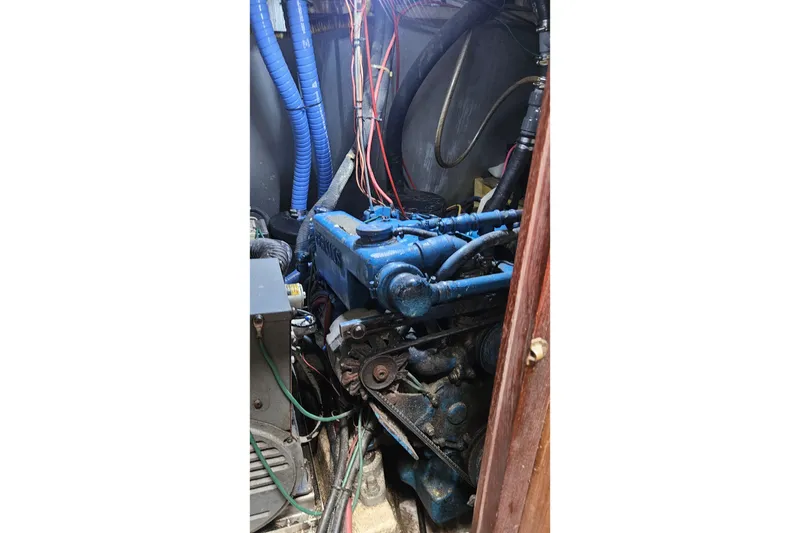 Slide: The Image of 1979 CSY 44 CC engine compartment with blue machinery and wiring. - 51
