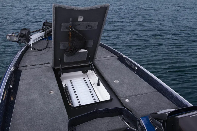 Slide: The Image of Manufacturer Provided Image: 2021 Skeeter FXR 21 boat with open storage compartment on water. - 7