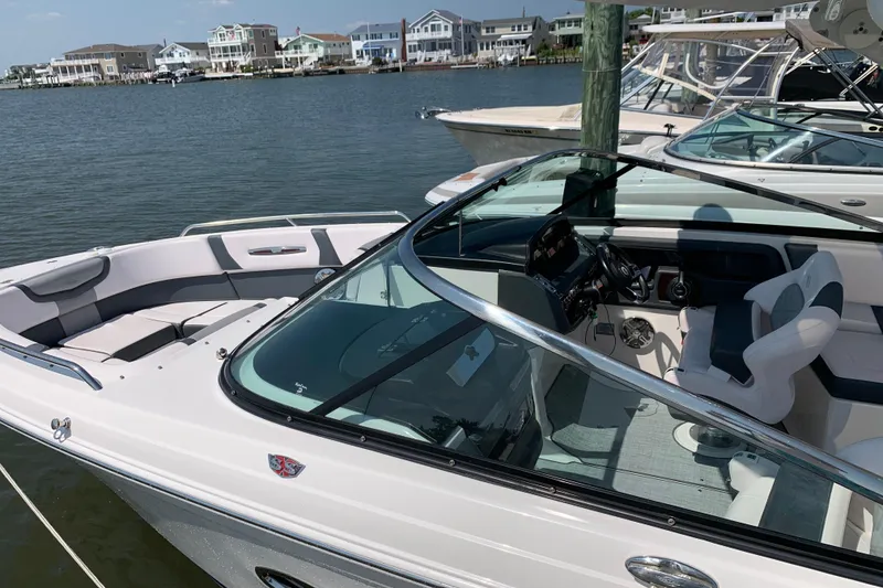 Slide: The Image of 2019 Chaparral 297 SSX boat docked on a sunny day. - 18