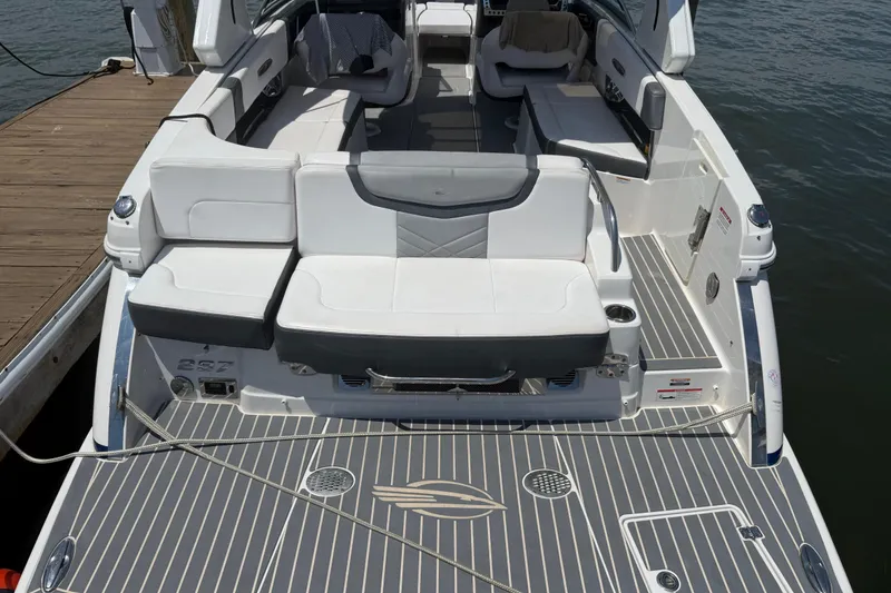 Slide: The Image of 2019 Chaparral 297 SSX boat docked with cover, rear view. - 22