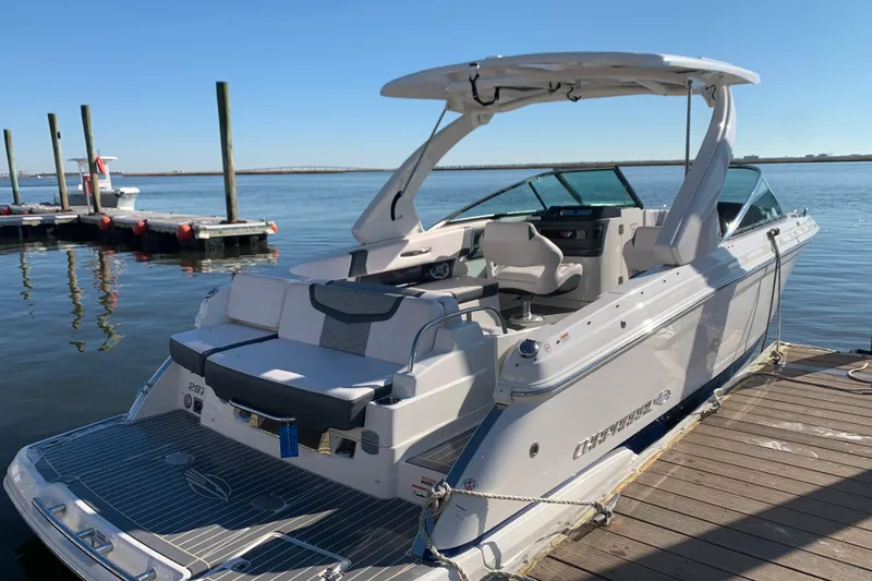 Slide: The Image of 2019 Chaparral 297 SSX boat docked, featuring spacious seating and sleek design. - 29