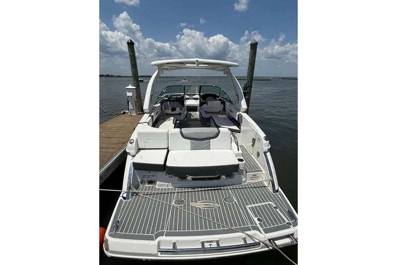 Slide: The Image of 2019 Chaparral 297 SSX boat docked, featuring spacious seating and sleek design. - 8