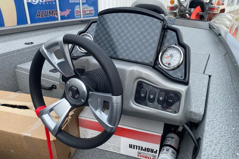 Slide: The Image of 2026 G3 Sportsman 1810 PFX boat dashboard with steering wheel and gauges. - 7