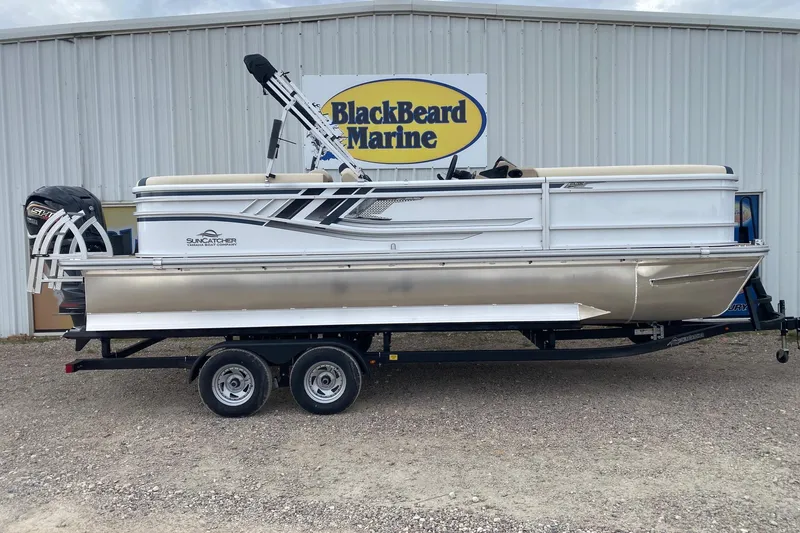 The Image of 2026 SunCatcher Select 322RC pontoon boat on trailer at BlackBeard Marine dealership. - 1