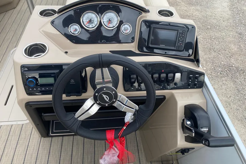 Slide: The Image of 2026 SunCatcher Select 322RC boat dashboard with steering wheel, gauges, and controls. - 10