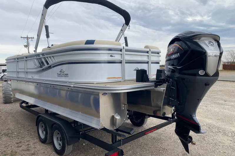 Slide: The Image of 2026 SunCatcher Select 322RC pontoon boat with Yamaha outboard motor on trailer. - 4
