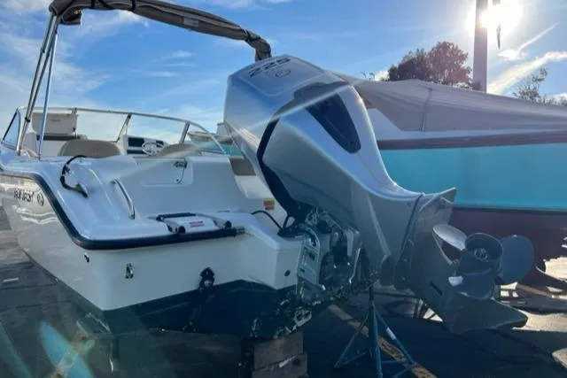Slide: The Image of 2017 Key West 239 DFS boat with outboard motor in a marina. - 10