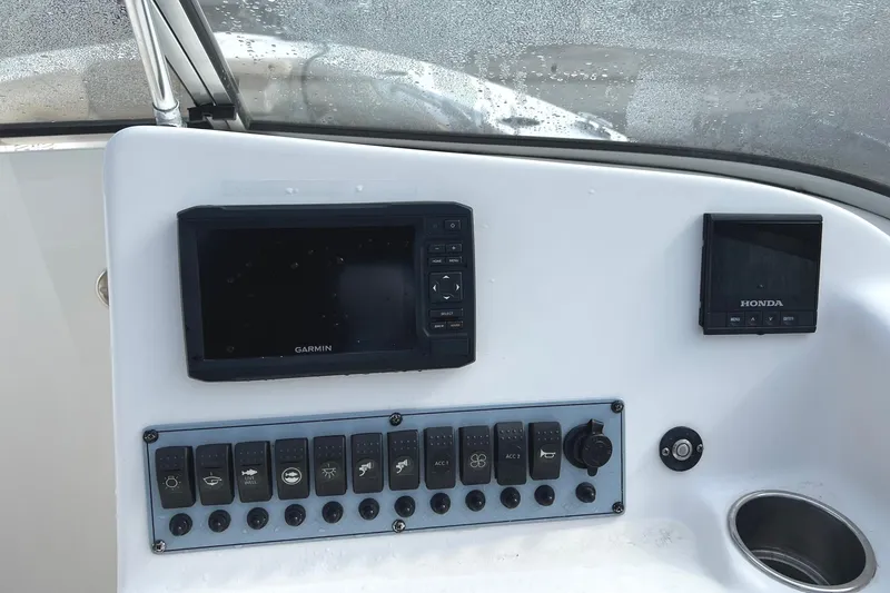 Slide: The Image of Control panel of a 2017 Key West 239 DFS boat with Garmin and Honda displays. - 13