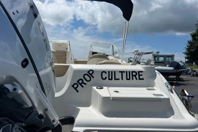 Slide: The Image of 2017 Key West 239 DFS boat with "Prop Culture" text, parked under a cloudy sky. - 2