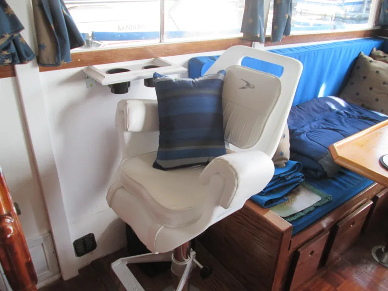 Slide: The Image of Interior of a 1966 Grand Banks 32 Sedan with white chair and cushion. - 16