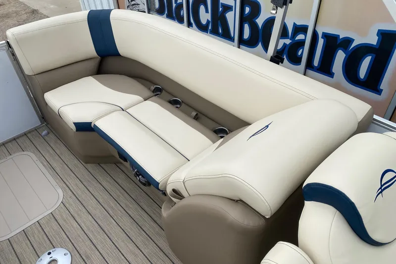 Slide: The Image of Luxurious seating on 2026 SunCatcher Select 322RC pontoon boat, featuring beige and blue upholstery. - 10