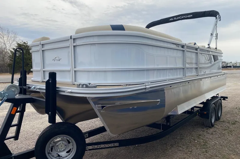 Slide: The Image of 2026 SunCatcher Select 322RC pontoon boat on trailer, featuring sleek design and durable construction. - 3