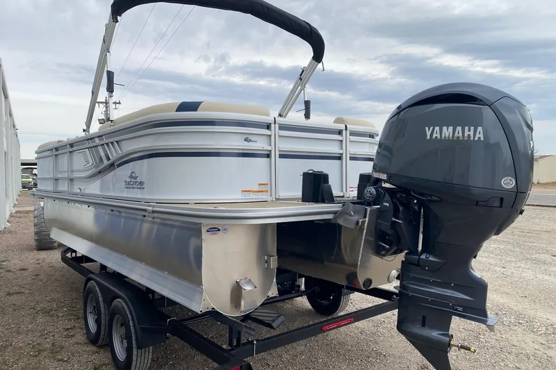 Slide: The Image of 2026 SunCatcher Select 322RC pontoon boat with Yamaha outboard motor on trailer. - 4