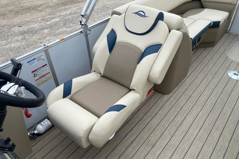 Slide: The Image of Luxurious seating on 2026 SunCatcher Select 322RC pontoon boat, featuring beige and blue upholstery. - 9