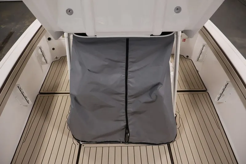 Slide: The Image of 2026 Yamaha Boats 195 FSH Sport interior with gray cover and sleek deck design. - 17