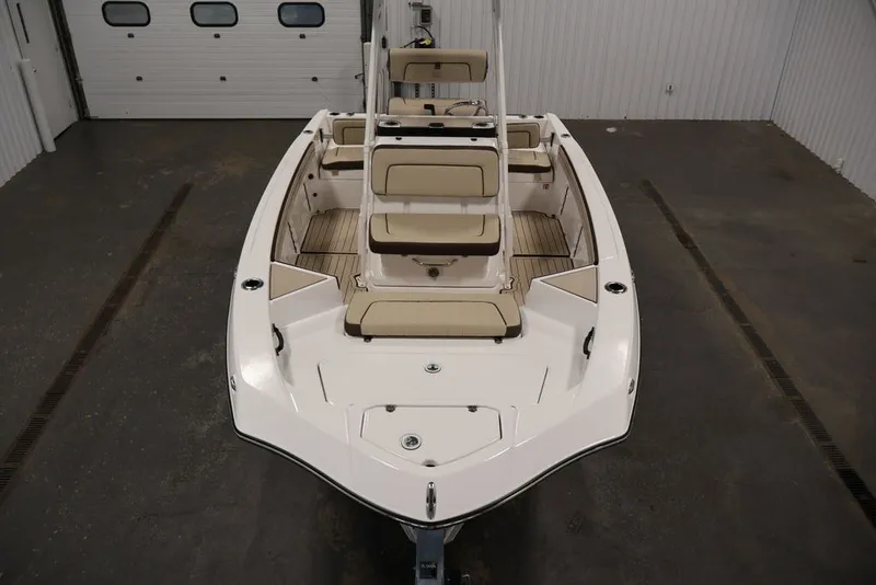 Slide: The Image of 2026 Yamaha Boats 195 FSH Sport in a showroom, showcasing sleek design and seating arrangement. - 15