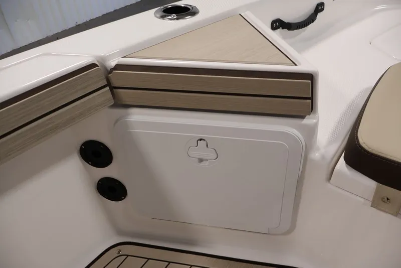 Slide: The Image of 2026 Yamaha Boats 195 FSH Sport interior detail with storage compartment and seating. - 18