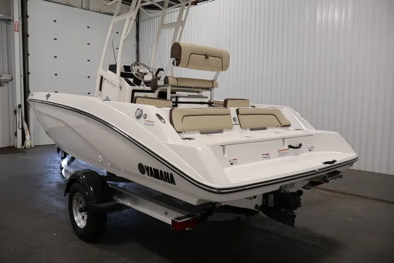 Slide: The Image of 2026 Yamaha Boats 195 FSH Sport in a showroom, showcasing sleek design and modern features. - 12