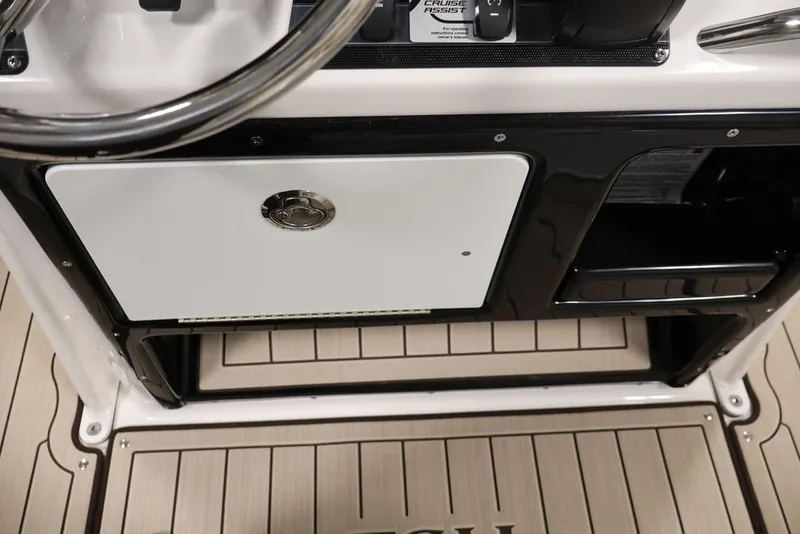 Slide: The Image of 2026 Yamaha Boats 195 FSH Sport dashboard with steering wheel and storage compartment. - 43