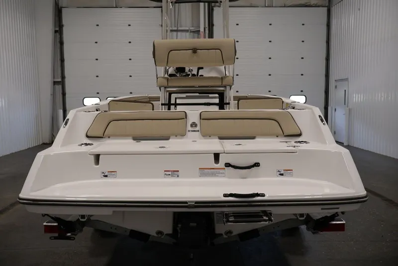 Slide: The Image of 2026 Yamaha Boats 195 FSH Sport, rear view in a garage setting. - 9