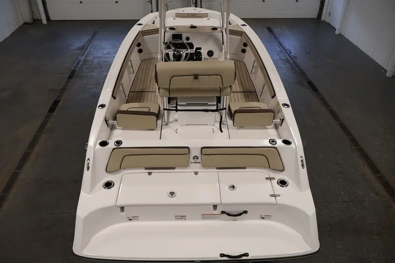 Slide: The Image of 2026 Yamaha Boats 195 FSH Sport interior, featuring beige seating and sleek design. - 11